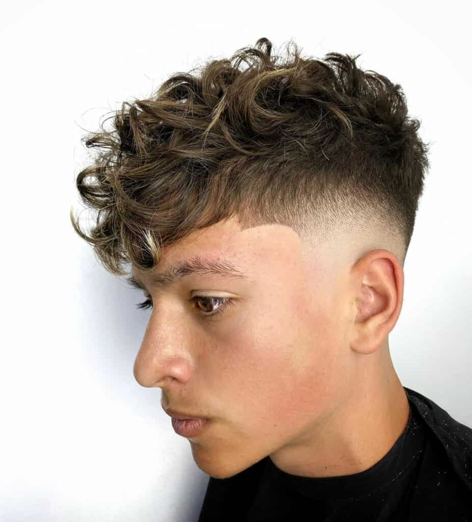 A Man with a Curly Fluffy Fade Haircut
