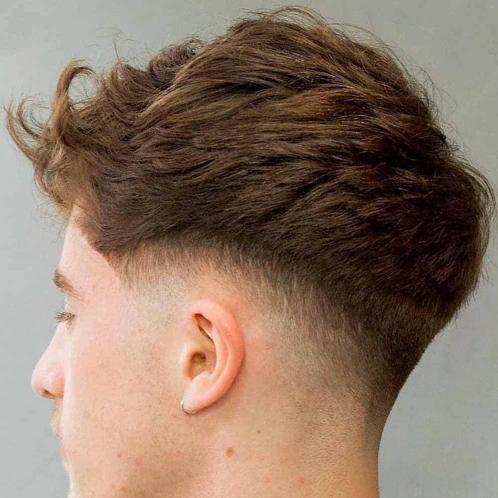 A young man with a Drop Fade Cut