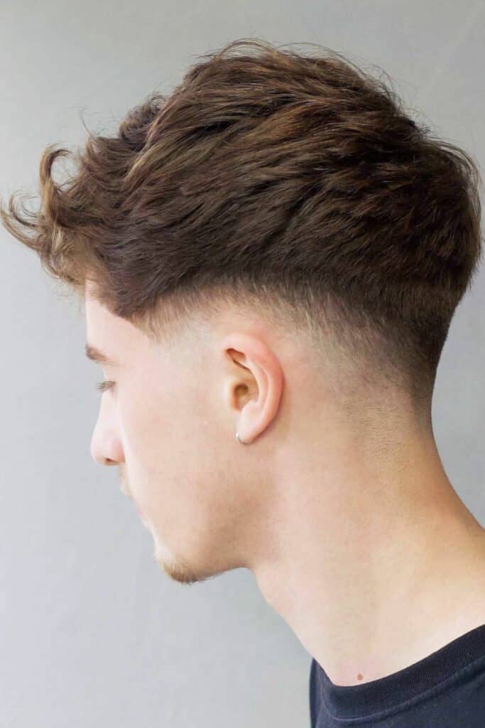A MAn with a Fluffy Fade Low Taper Cut