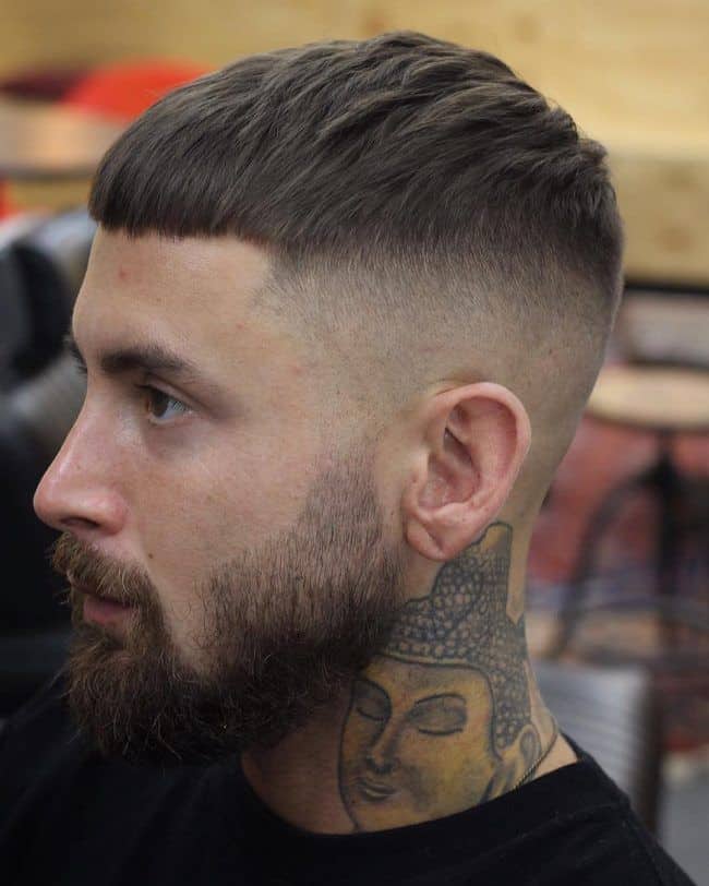 A man with a Straight Hair Fade Cut and a tattoo